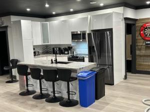 a kitchen with a large island with bar stools at Long Lake Escape in Hammonds Plains