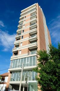 a tall building with a blue sky in the background at Koñi Nqn in Neuquén