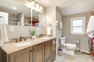 a bathroom with two sinks and a toilet at 2 Mi to Gillette Stadium Foxborough Retreat! in Foxborough +18 photos