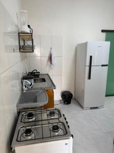 a kitchen with a stove and a refrigerator at Belas Praias Itacaré 2 in Itacaré