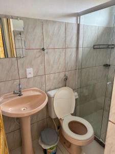a bathroom with a toilet and a sink and a shower at Belas Praias Itacaré 2 in Itacaré