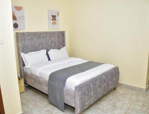 a bedroom with a large bed in a room at Elegant 2 bedroom fully furnished at 360 in Kitale