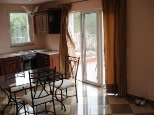 a kitchen with a table and chairs and a kitchen with a balcony at Old Town Vrbnik Villas in Vrbnik