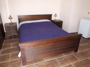 a bedroom with a bed and two night stands at Old Town Vrbnik Villas in Vrbnik