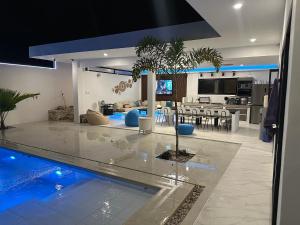 a living room and kitchen with a swimming pool at La Celeste Samal in Libuak