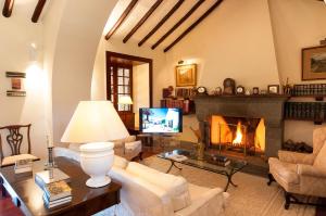 a living room with a fireplace and a tv at Mansion Bandama by VillaGranCanaria in Tafira