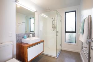 a bathroom with a sink and a shower at Mapua41South in Mapua +26 photos
