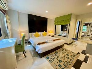 a hotel room with a bed and a desk and a room at Ayara Grand Palace Hotel in Phitsanulok +56 photos