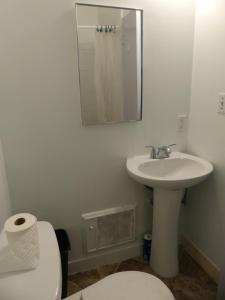 a bathroom with a sink and a toilet and a mirror at Wilshire Orange Hotel in Los Angeles +37 photos