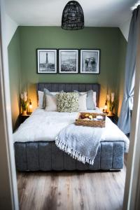 a bedroom with a large bed and a green wall at Vance Retreat in Blackpool