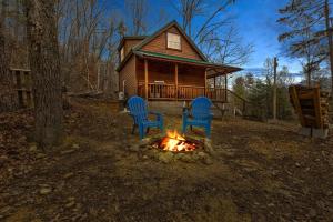 StantonThe Deer Run的小木屋前的壁炉旁摆放着两把椅子