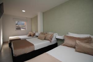 Voodi või voodid majutusasutuse DAM Hotel Pereira toas
