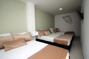 Voodi või voodid majutusasutuse DAM Hotel Pereira toas