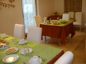 a dining room with two tables with food on them at Agritur All'Olivo in Faver