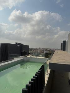 a swimming pool on the roof of a building at Luxury Nova Roman Ridge 2-bedroom apartment in Accra - FiveHills homes in Accra