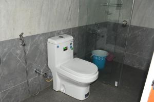 a bathroom with a toilet and a shower at Ghala Residency in Munnar +18 photos