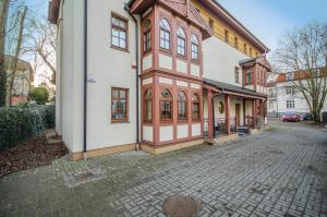 a large building with a red and white at Dom & House - Apartamenty Zacisze in Sopot