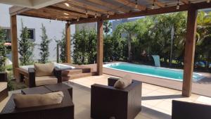 a backyard with a swimming pool and a pavilion at Casa Condomínio Ocean Side Torres in Torres