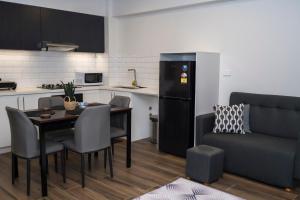 a kitchen and dining room with a table and a couch at Garden Apartments in Nadi