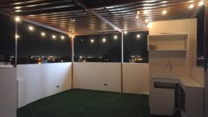 a room with a view of the city at night at CARDOS HOSTAL in Pisco +25 photos