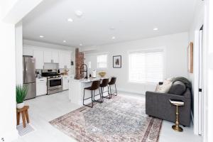 a living room with a couch and a kitchen at Adjoining Condominium Units Sleeps 12 in Downtown Sandusky! in Sandusky