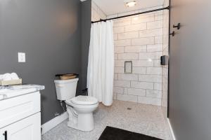 a bathroom with a toilet and a shower at Adjoining Condominium Units Sleeps 12 in Downtown Sandusky! in Sandusky +18 photos