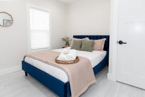 a bedroom with a blue and white bed with a blanket at Adjoining Condominium Units Sleeps 12 in Downtown Sandusky! in Sandusky