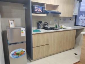 a kitchen with a sink and a refrigerator at Departamento centrico, pasos a Embajada Americana, Multicine in La Paz +16 photos