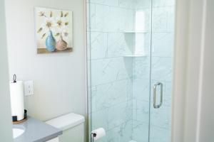 a bathroom with a glass shower with a sink at Hidden Gem 2 in Norristown