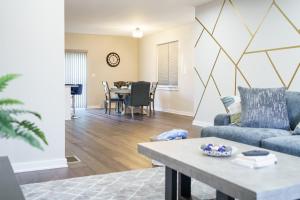 a living room with a couch and a table at Hidden Gem 2 in Norristown +7 photos