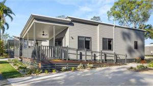 a modular home with a porch and balcony at Discovery Parks - Forster in Tuncurry