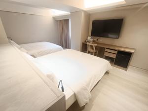 Postel nebo postele na pokoji v ubytování 衿后禾居Good Hotel