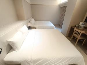 Postel nebo postele na pokoji v ubytování 衿后禾居Good Hotel