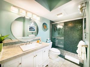 a bathroom with a sink and a toilet and a mirror at Penthouse With Fabulous Ocean View Near Waikiki Beach in Honolulu