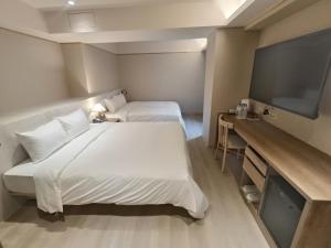Postel nebo postele na pokoji v ubytování 衿后禾居Good Hotel