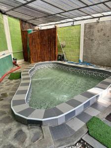 a swimming pool in the middle of a yard at Villa Tagar Hidayah in Ciwidey +7 photos