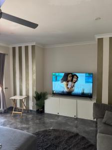 a living room with a flat screen tv on a wall at Mahzan on Dromana Room 2 in Truganina