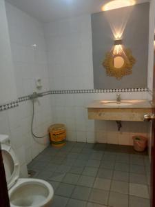 a bathroom with a sink and a toilet at Kondominium pantai Lippo Carita pdg in Sukarame