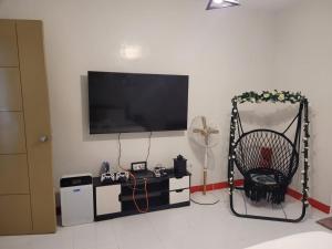 a living room with a flat screen tv on a wall at Serenity Homes with Indoor Jacuzzi in Lipa