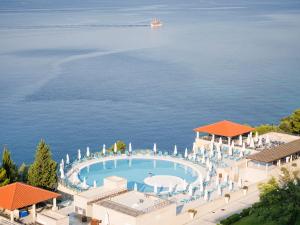 an aerial view of a resort with a pool and the ocean at Sun Gardens Dubrovnik in Dubrovnik
