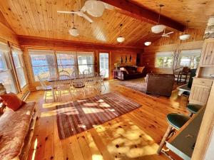 a living room with a couch and a table and chairs at BEAR POINT LIMIT 15 villa in Harrison