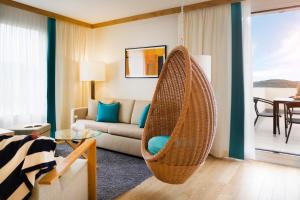 a living room with a rattan hanging chair at Sun Gardens Dubrovnik in Dubrovnik