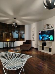 a living room with a couch and a tv at Pacific Spot San Miguel in Lima
