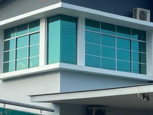 a building with glass windows on the side of it at Sandakan Js homestay in Sandakan