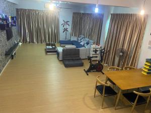 a living room with a couch and a table at Sandakan Js homestay in Sandakan