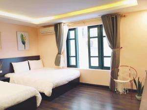 a bedroom with two beds and a window at Hello Sapa 2 in Sa Pa