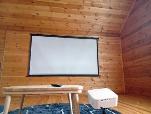 a room with a white screen in a wooden wall at 民泊ゆとろぎ in Ema