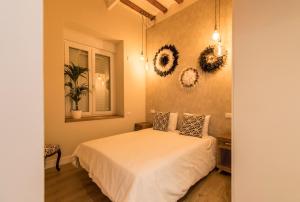 a bedroom with a white bed and a window at Loft chic luminoso in Madrid +8 photos