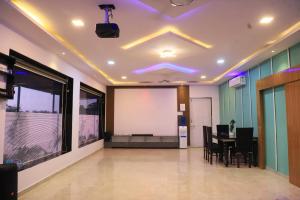 a conference room with a table and a white screen at Wander Away Villa Karjat by Natura Stays in Dhamni