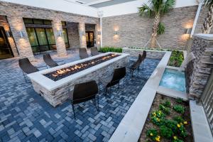 an outdoor patio with a fire pit and chairs at Courtyard by Marriott Lake Jackson in Lake Jackson
